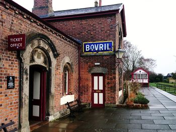 Road sign against built structure