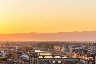 Sunset view of florence in italy with a airliner that lifts