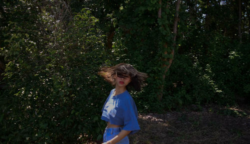 Side view of a teenage girl standing on land