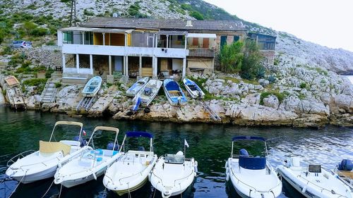 Boats moored on river by building