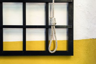 Close-up of rope noose against wall