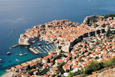 High angle view of townscape by sea