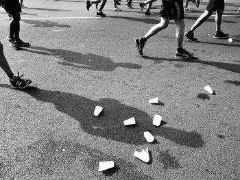 Low section of people walking on street