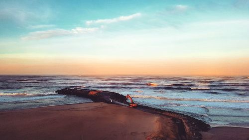 Scenic view of beach against sky during sunset