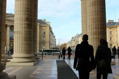 Rear view of couple walking at st-louis-des-invalides against sky