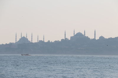 Panoramic view of sea and buildings against sky