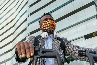 Low angle view of man holding camera