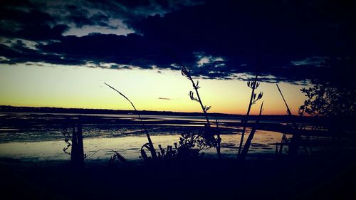 Scenic view of lake against sky at sunset