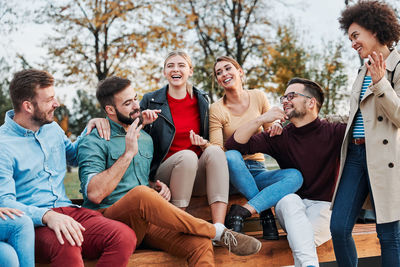 Young couple sitting in a group of people