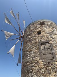 Low angle view of traditional windmill against sky
