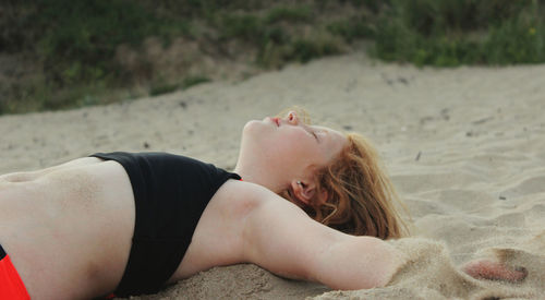 Carefree girl lying on sand