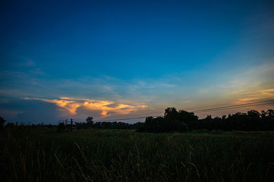 Scenic view of field against sky during sunset