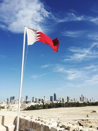 Flag against sky in city