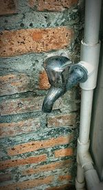 Close-up of faucet against wall