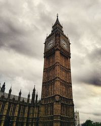 Low angle view of big ben against cloudy sky