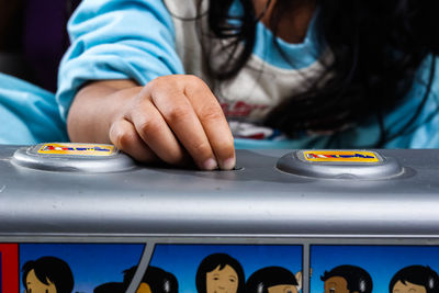 Midsection of woman playing guitar on table