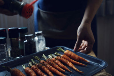 Midsection of woman preparing food on table