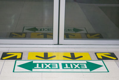 Close-up of yellow sign on glass window