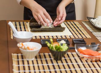 Midsection of person preparing food on table