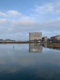 Reflection of buildings in lake against sky