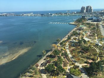 High angle view of buildings by sea against sky