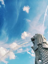 Low angle view of statue against blue sky