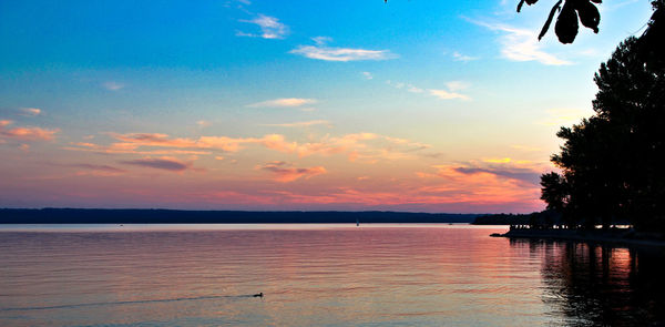 Scenic view of lake against sky during sunset