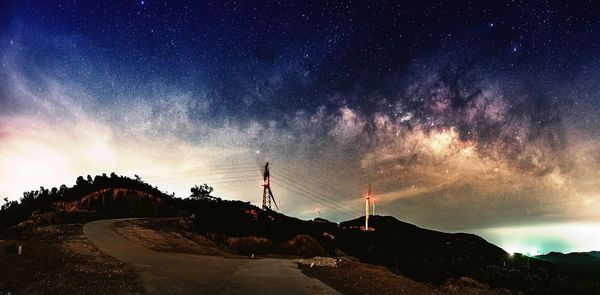 Panoramic view of landscape against sky at night