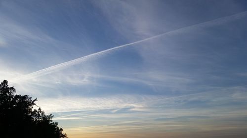 Low angle view of vapor trails in sky