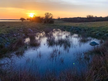 Scenic view of lake against sky during sunset