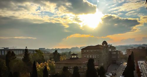 View of cityscape against cloudy sky
