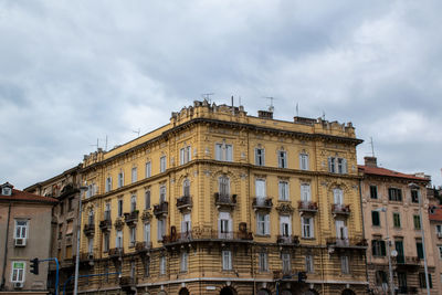 Low angle view of building against cloudy sky