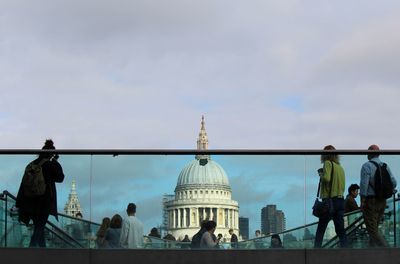 People in city against sky