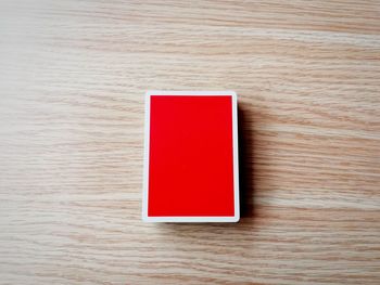 High angle view of red telephone on table