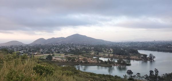 Scenic view of lake by mountains against sky