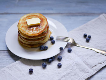 Pancakes and blueberries on table