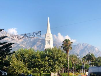 Panoramic view of trees and buildings against sky