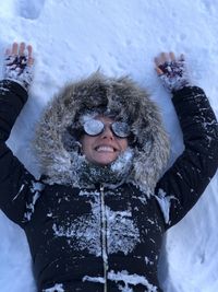 Portrait of smiling young woman in snow