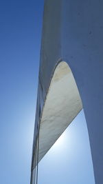 Low angle view of bridge against clear blue sky