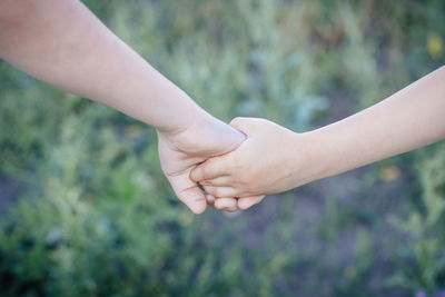 Close-up of couple hands against blurred background