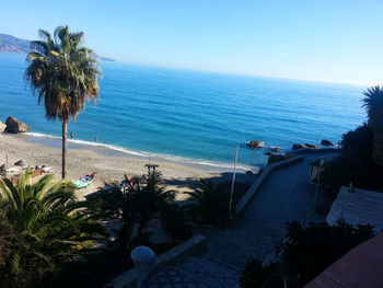 Scenic view of beach against blue sky