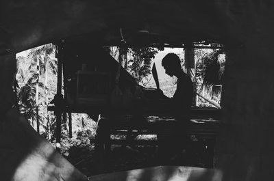 Woman sitting in abandoned building