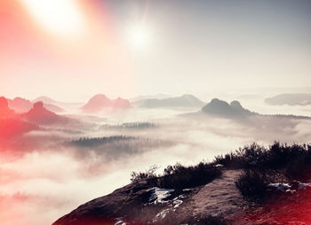 Scenic view of mountains against sky during sunset