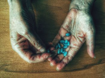 Close-up of hands holding pills