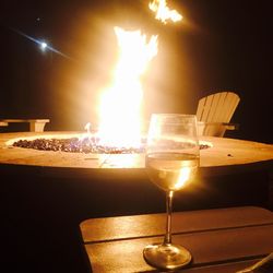 Close-up of illuminated tea light candle on table