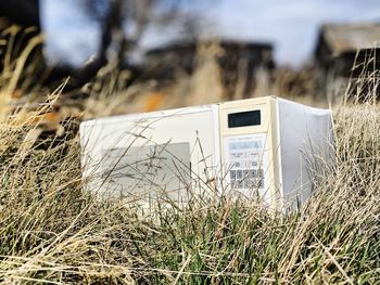 Close-up of old abandoned house on field