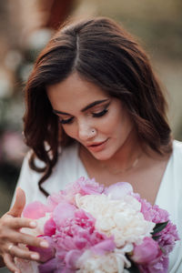 Close-up of woman with pink roses