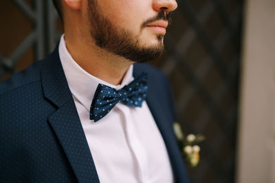 Close-up of man standing against wall