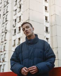 Young man looking away in city