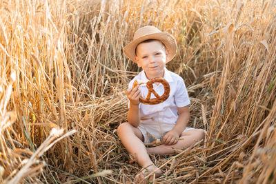 Portrait of cute girl sitting on hay